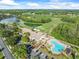 An expansive aerial view of a clubhouse, pool, and golf course at 7606 Berna Ln, Land O Lakes, FL 34637