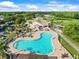 An engaging aerial view of a sparkling community pool and clubhouse at 7606 Berna Ln, Land O Lakes, FL 34637