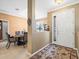 Open dining area with elegant decor and a view of the home's entry, perfect for gatherings at 7606 Berna Ln, Land O Lakes, FL 34637