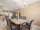 Elegant dining room with chandelier and striped chairs at 7606 Berna Ln, Land O Lakes, FL 34637
