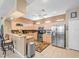 Spacious kitchen with stainless steel appliances and breakfast bar seating at 7606 Berna Ln, Land O Lakes, FL 34637