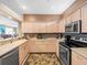 Well-lit kitchen with stainless appliances and ample counter space at 7606 Berna Ln, Land O Lakes, FL 34637
