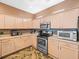 Bright kitchen with stainless steel appliances and granite countertops at 7606 Berna Ln, Land O Lakes, FL 34637