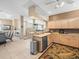 Bright kitchen featuring tile floors, stylish cabinets, modern appliances, and an open layout to the dining area at 7606 Berna Ln, Land O Lakes, FL 34637