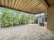 Spacious screened lanai featuring a brick patio and tranquil view of the water at 7606 Berna Ln, Land O Lakes, FL 34637