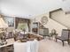 Spacious living room with tile floors, staircase access, comfortable seating, and sliding door access to the outdoors at 7606 Berna Ln, Land O Lakes, FL 34637