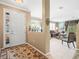 Spacious entry way with a decorative rug, offering a glimpse into the living room and adjacent dining area at 7606 Berna Ln, Land O Lakes, FL 34637