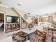 Expansive living room showcasing tile floors, a staircase, television, and comfortable seating at 7606 Berna Ln, Land O Lakes, FL 34637