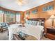Bright main bedroom with large bed, window, and warm color scheme at 7606 Berna Ln, Land O Lakes, FL 34637