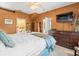 Spacious main bedroom showcasing a large dresser, ceiling fan, and ensuite bathroom access at 7606 Berna Ln, Land O Lakes, FL 34637