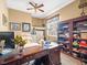 Home office with wooden desk, built-in bookshelves, and natural light at 7606 Berna Ln, Land O Lakes, FL 34637