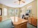 Comfortable office space with natural light and ample workspace on a large wooden desk at 7606 Berna Ln, Land O Lakes, FL 34637