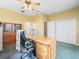 Bright office features a ceiling fan, wood desk, and built-in shelving for a comfortable workspace at 7606 Berna Ln, Land O Lakes, FL 34637