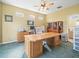 Bright office featuring a large desk, computer setup, and natural light at 7606 Berna Ln, Land O Lakes, FL 34637
