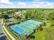 A vibrant aerial view of well-maintained tennis courts at 7606 Berna Ln, Land O Lakes, FL 34637