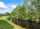 Scenic water view with lush green landscaping along the bank at 7606 Berna Ln, Land O Lakes, FL 34637
