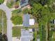 Bird's eye view of a quaint home with a neatly maintained yard, complemented by mature trees at 7704 Tanglewood Ln, Tampa, FL 33615