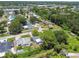 Overview of a residential area featuring well-kept houses surrounded by mature trees and landscaping at 7704 Tanglewood Ln, Tampa, FL 33615