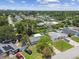 Aerial view of a residential neighborhood showcasing a well-maintained home with mature trees at 7704 Tanglewood Ln, Tampa, FL 33615