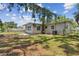 Spacious backyard view featuring a well-maintained lawn and mature trees at 7704 Tanglewood Ln, Tampa, FL 33615