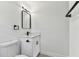 Bright bathroom showcasing white fixtures, modern vanity, and minimalist design at 7704 Tanglewood Ln, Tampa, FL 33615