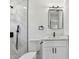Bathroom featuring a vanity with modern fixtures, a black framed mirror, and a tiled shower at 7704 Tanglewood Ln, Tampa, FL 33615