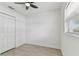 Bright, neutral bedroom features modern ceiling fan and vinyl flooring at 7704 Tanglewood Ln, Tampa, FL 33615