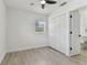 Bright bedroom with a ceiling fan, wood-look floors, a window, and large closet at 7704 Tanglewood Ln, Tampa, FL 33615