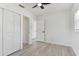 Bright bedroom with a ceiling fan, wood-look floors, a window, and large closet at 7704 Tanglewood Ln, Tampa, FL 33615