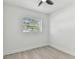 Bright, neutral bedroom features modern ceiling fan and vinyl flooring at 7704 Tanglewood Ln, Tampa, FL 33615