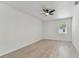 A calming bedroom with a modern ceiling fan and natural light from the window at 7704 Tanglewood Ln, Tampa, FL 33615