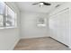 Bedroom with bright white walls, wood-look flooring, and large closet with bifold doors at 7704 Tanglewood Ln, Tampa, FL 33615