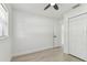 Bright, neutral bedroom features modern ceiling fan and vinyl flooring at 7704 Tanglewood Ln, Tampa, FL 33615
