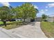 Inviting single-story home with a well-manicured lawn and a paved driveway at 7704 Tanglewood Ln, Tampa, FL 33615