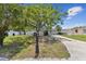 Well-maintained single-story home featuring a lush green lawn and mature trees at 7704 Tanglewood Ln, Tampa, FL 33615