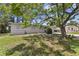 Well-kept single-story home with a big shade tree and fenced yard at 7704 Tanglewood Ln, Tampa, FL 33615