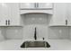 Close-up shot of modern eat-in kitchen with white cabinets and stainless steel sink at 7704 Tanglewood Ln, Tampa, FL 33615