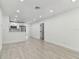 Bright, open-concept living space with sleek floors and direct access to the kitchen at 7704 Tanglewood Ln, Tampa, FL 33615