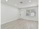 Clean, bright living room features modern floors and a large window for natural light at 7704 Tanglewood Ln, Tampa, FL 33615