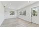 Bright living room features recessed lighting, light wood floors, and a window for natural light at 7704 Tanglewood Ln, Tampa, FL 33615