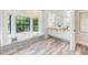 Elegant bathroom boasting a soaking tub under large windows and dual vanities with ample space at 7803 Mathern Ct, Lakewood Ranch, FL 34202
