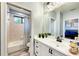 Bathroom showcasing updated vanity with large mirror and updated fixtures and lighting at 7803 Mathern Ct, Lakewood Ranch, FL 34202
