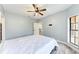 Bedroom with a ceiling fan and a view of the hallway at 7803 Mathern Ct, Lakewood Ranch, FL 34202