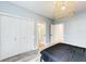 Bedroom showcasing ample closet space, neutral walls, and wood-look flooring at 7803 Mathern Ct, Lakewood Ranch, FL 34202