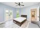 Bedroom features French doors leading to the patio, a ceiling fan, and an ensuite bathroom at 7803 Mathern Ct, Lakewood Ranch, FL 34202