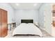 Neutral bedroom with a bed, a desk and a wooden wardrobe with white trim at 7803 Mathern Ct, Lakewood Ranch, FL 34202