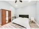 Comfortable bedroom featuring a queen-size bed, wardrobe closet and a chair at 7803 Mathern Ct, Lakewood Ranch, FL 34202