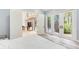 Bedroom with a white bed, French doors, and view of the pool at 7803 Mathern Ct, Lakewood Ranch, FL 34202
