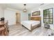 Spacious bedroom with tray ceilings and views to the outdoor area via black trimmed windows at 7803 Mathern Ct, Lakewood Ranch, FL 34202