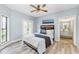 Beautiful bedroom with light blue walls, stylish ceiling fan, and en suite bathroom access at 7803 Mathern Ct, Lakewood Ranch, FL 34202